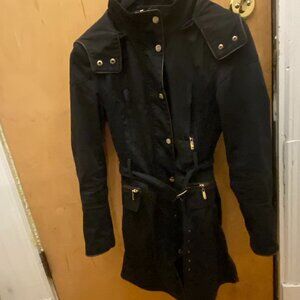 Parisian chic black trench coat with gold zipper accents and a belted waist